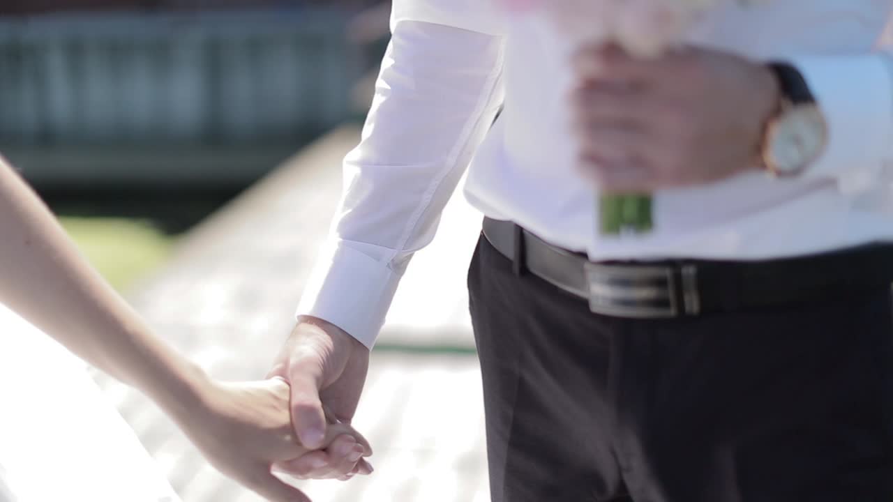 Bride And Groom On Wooden Bridge. Bride and groom on pier walking , holding hands