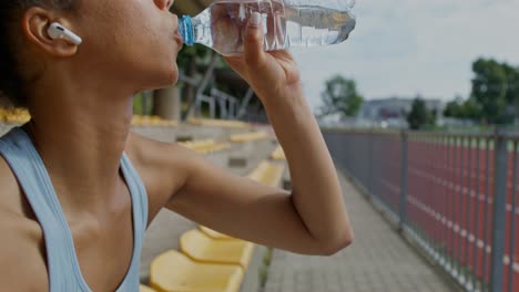 woman athlete taking a break at the stadium