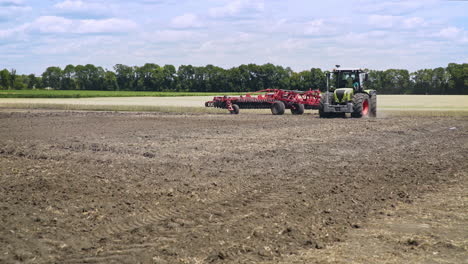 Agricultural-tractor-plowing-field.-Process-plowing-arable-field.-Plowed-land