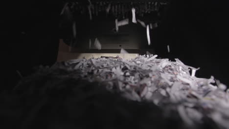 shredder cutting paper from below, full basket, wide-angle