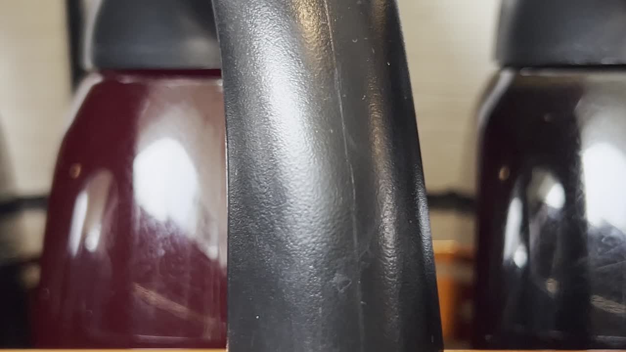 Coffee machine dispensing rich, aromatic coffee into glass containers on a self-service breakfast buffet, creating a welcoming atmosphere in a hotel dining area