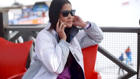 Young-woman-relaxing-at-an-alpine-ski-resort