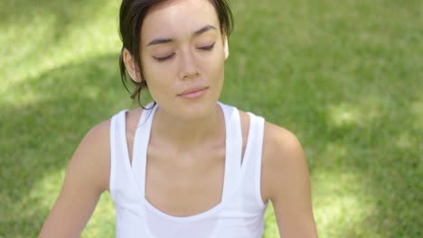 calm young woman in white blouse with grin