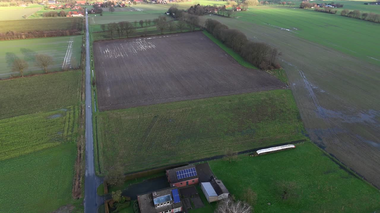 Farm House in rural countryside of USA after heavy rain. Flooded agricultural fields in american countryside. Aerial top down flyover shot.
