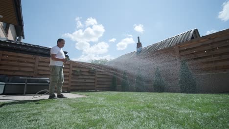 hombre colocando césped en el jardín del patio trasero para la instalación de césped y proyecto de jardinería, centrado en la mejora del hogar y el mantenimiento al aire libre para un césped fresco y verde en un patio residencial