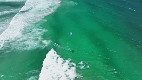 Aerial-view-of-skilled-tourists-and-locals-kite-surfing-at-Platboom-near-Cape-Town
