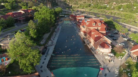 Aerial-approach-over-people-in-the-Glenwood-Hot-Springs-in-Glenwood-Springs,-Colorado