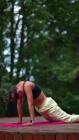 woman practicing yoga in a forest setting