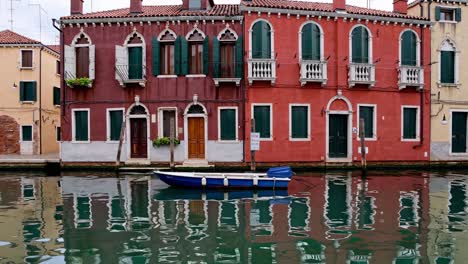 colorful venetian canal houses and a small boat