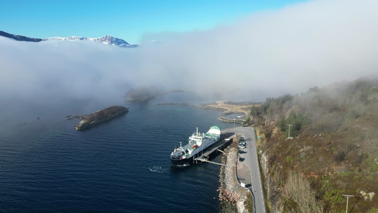 There is thick fog over the fjord when the car ferry MF &amp;quot;Haram&amp;quot; leaves the quay at Dryne on its way to Brattv&aring;g, just north of &Aring;lesund, Norway