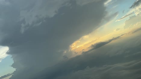 pastel colors sky during a right turn in a stormy sky shot from a jet cockpit