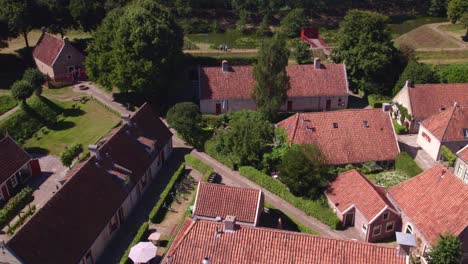 Drone-view-of-small-houses-at-Fortress-Bourtange-Holland-during-bright-summer-day,-aerial