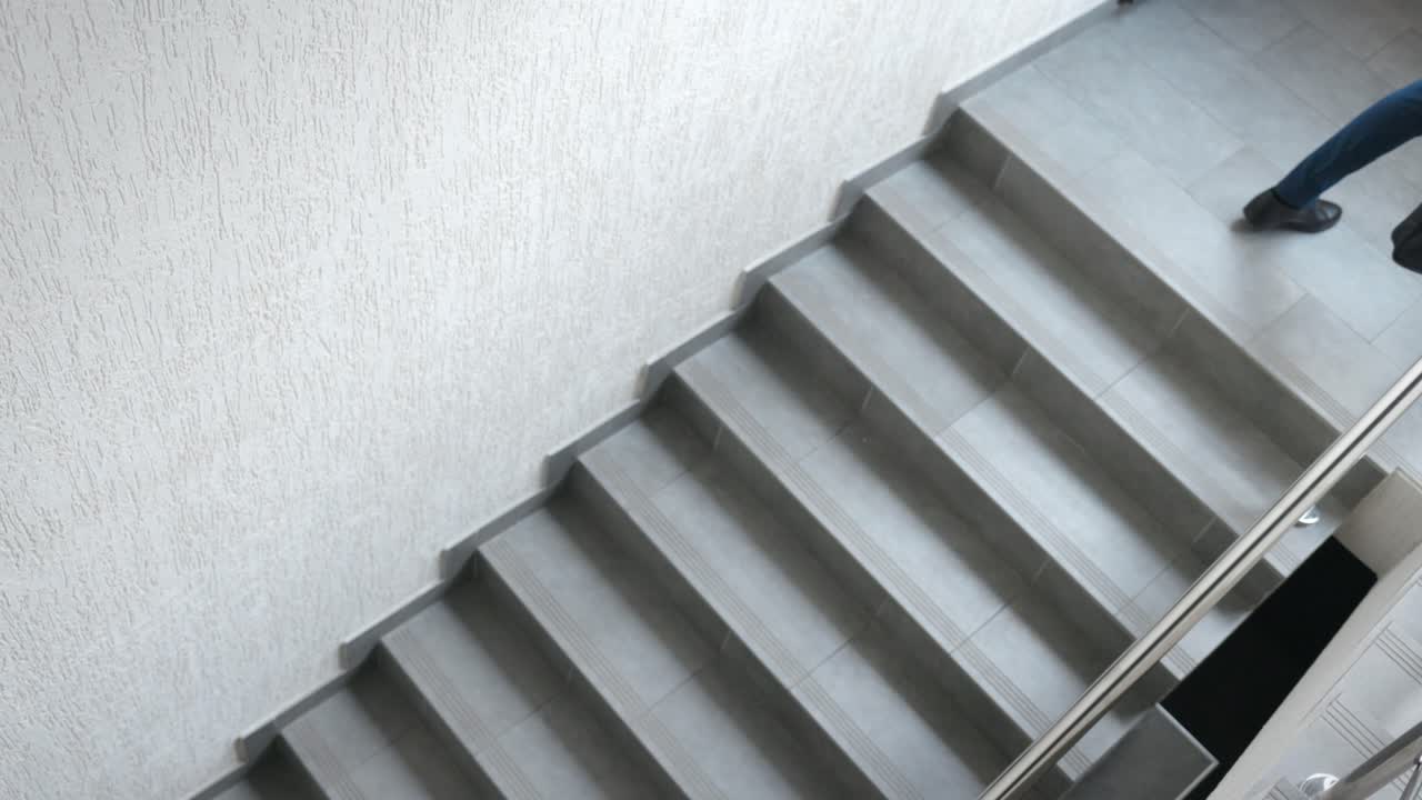 Businessman walking up stairs in office building