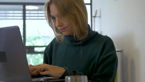 Portrait-Shot-of-a-Creative-Woman-Sitting-at-Her-Desk-at-home