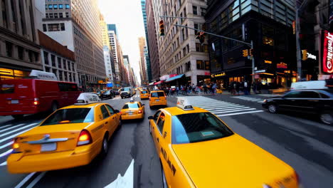 dynamic view of yellow taxis and traffic on a busy new york city street