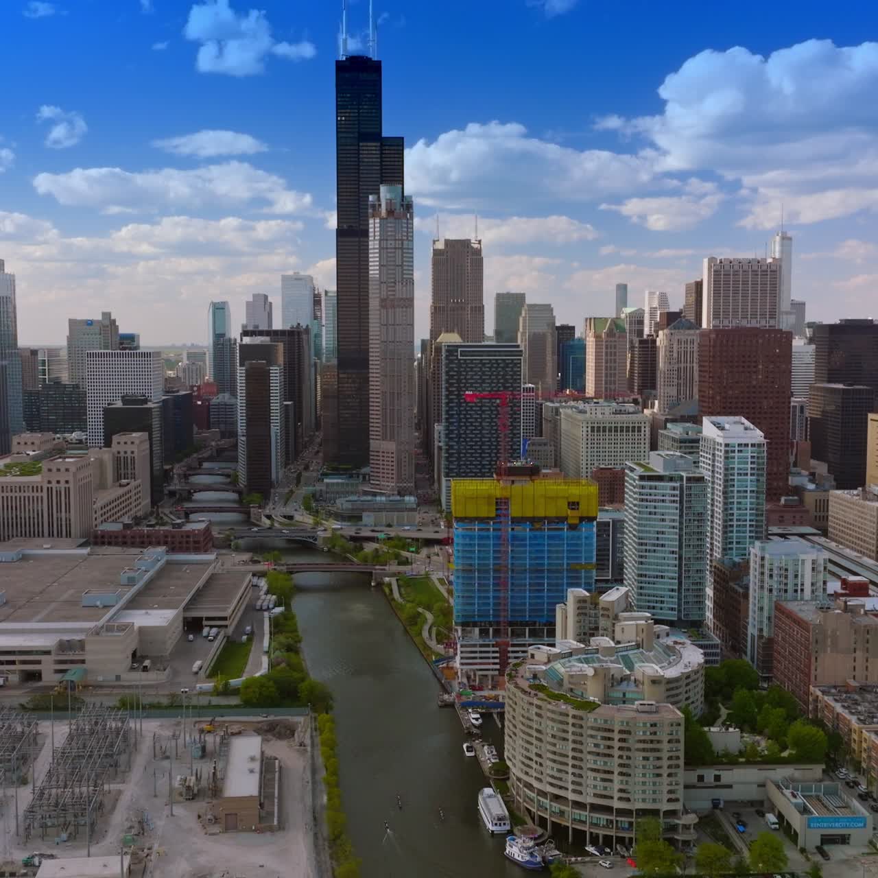 Construction site nearby underground railways in Chicago. Drone footage over Chicago River approaching skyscrapers