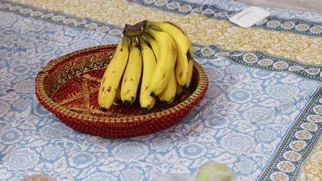 yellow-ripe-banana-kept-at-decorated-plate-from-flat-angle