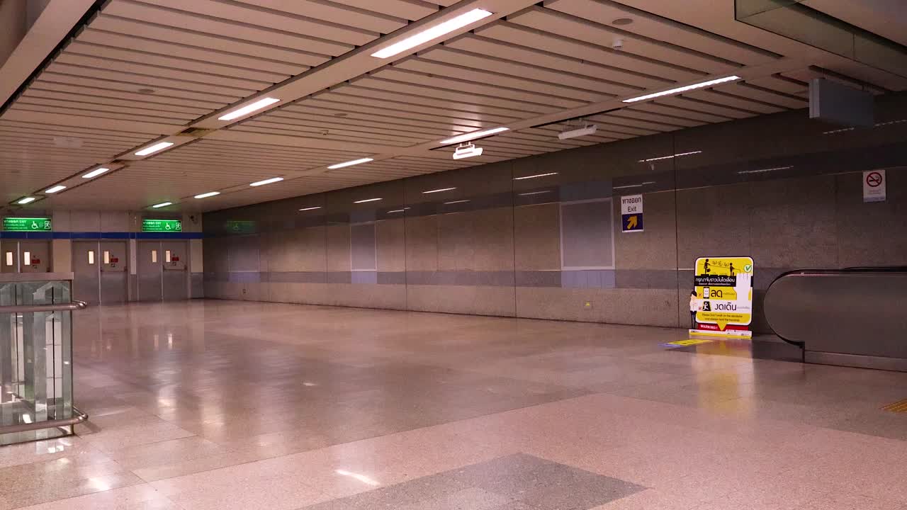 A serene journey through an empty Bangkok MRT station, focusing on escalator movement and architectural details under soft lighting