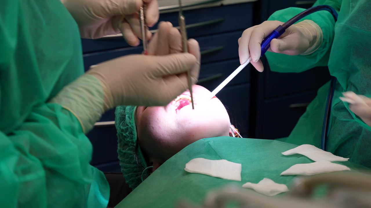 Dentist biopsying a piece of his patient's palate. Close up, 4K