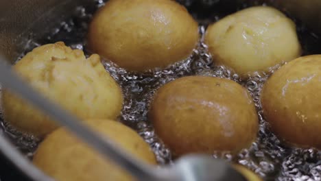 cooking donuts in the kitchen. saucepan with boiling oil