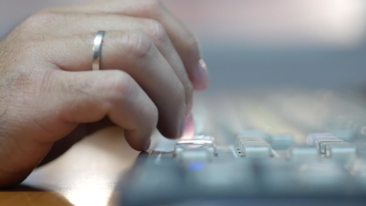 primer plano de una mano masculina presionando botones en un tablero de interruptores para producción y transmisión de televisión