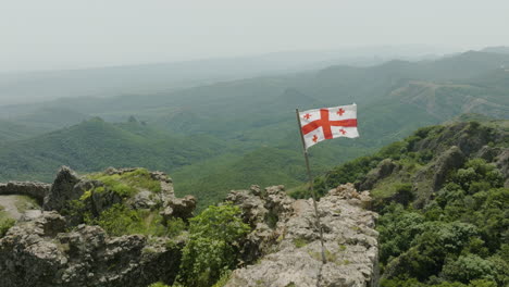 historical citadel from xi century and a georgian flag fluttering on wind