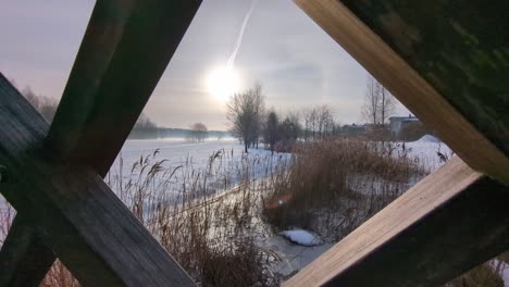 calm snowy winter river landscape view from bridge in countryside