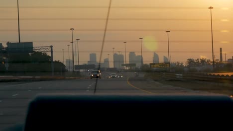 sunrise over toronto out of the back window of a moving car