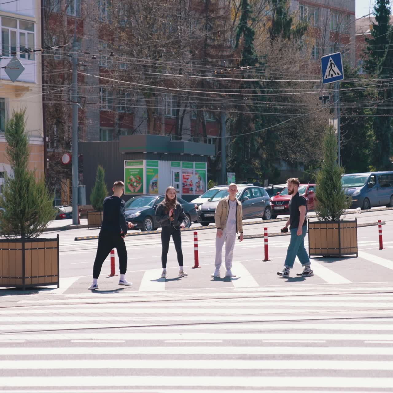 Hipster young people doing tricks in the city street. Joyful friends having fun together on the city transport background. Youth culture