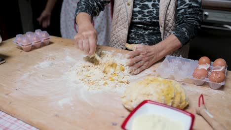 Crop-woman-preparing-dough-at-table-in-kitchen