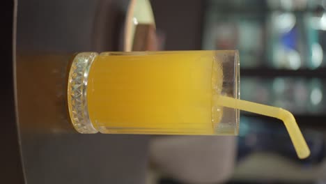 orange juice in a glass with straw