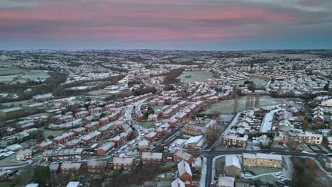 cinematic urban aerial winter view of a delicate pink and blue early morning sunrise sky