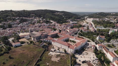 portugal historical cityscape and catholic monastic complex alcobaça monastery, aerial pan shot