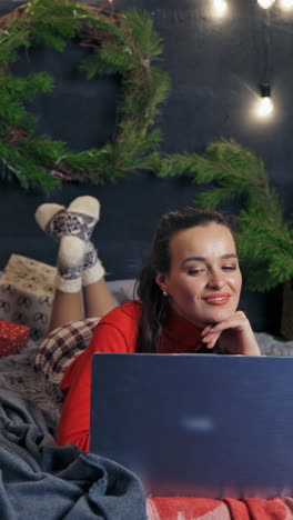 woman lying on bed with laptop. beautiful girl lying on bed with laptop computer