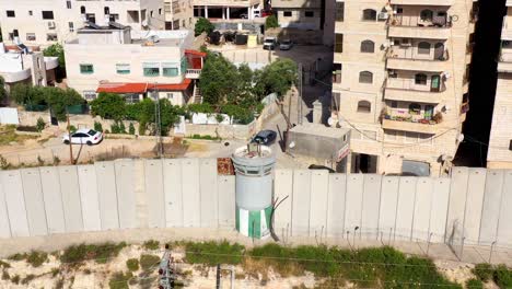 aerial view of a security wall and watchtower in an urban residential area