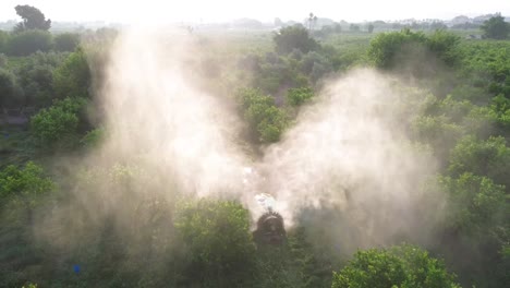 tractor spraying pesticide drone aerial view, pesticides or insecticide spray on lettuce or iceberg field. pesticides and insecticides on agricultural field in spain