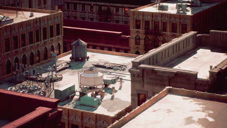 aerial view of city rooftops with water towers and air conditioners