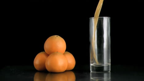 Tangerine-juice-being-poured-in-super-slow-motion