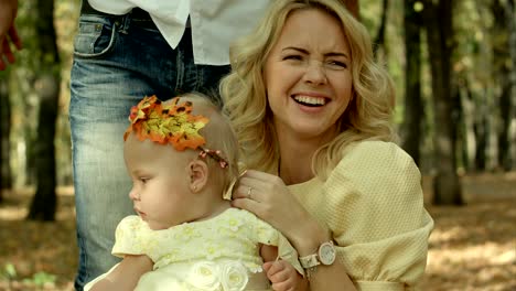 happy young mother with daughter in autumn park