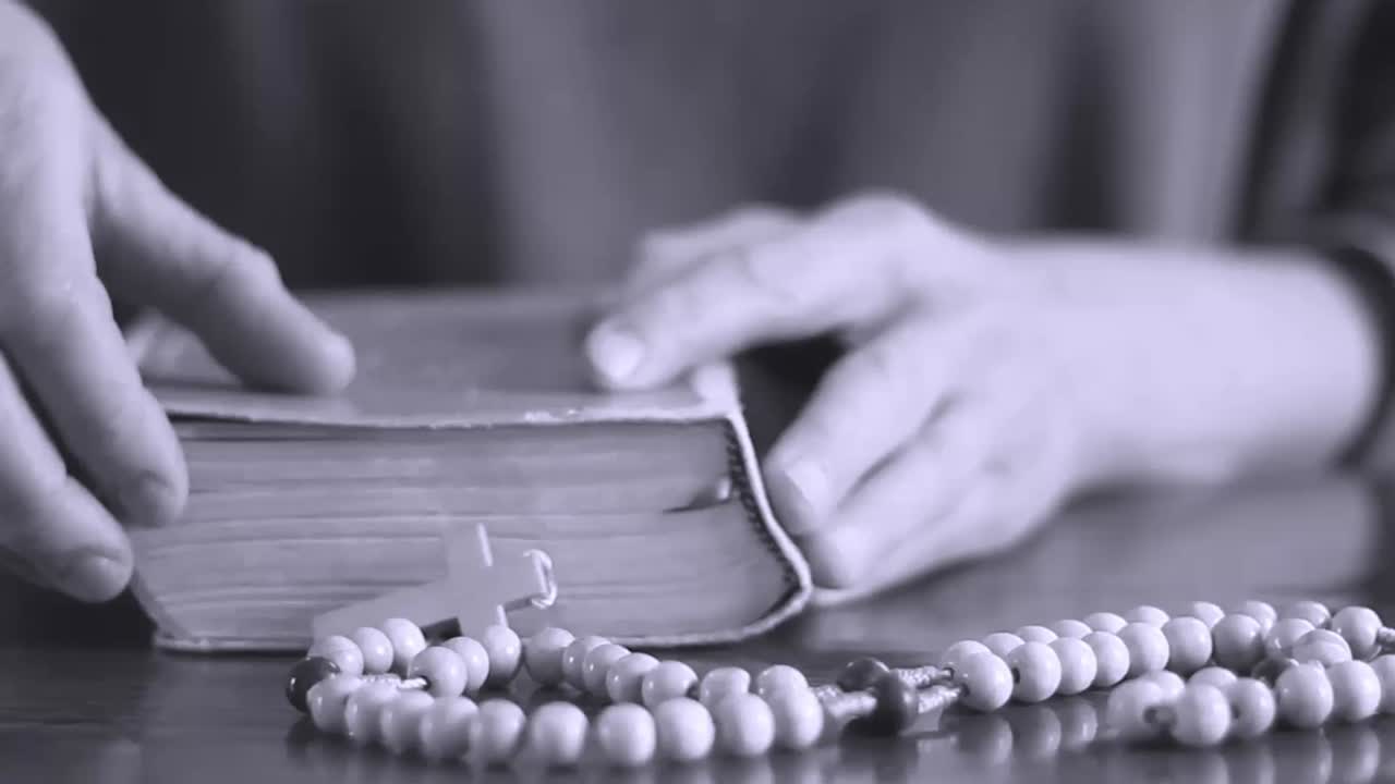 Video in stock di persone che pregano Dio con la Bibbia