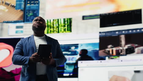 black social media manager engaging with social network trends on screens