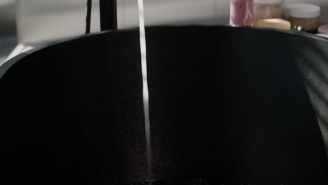 filling a black tub with water
