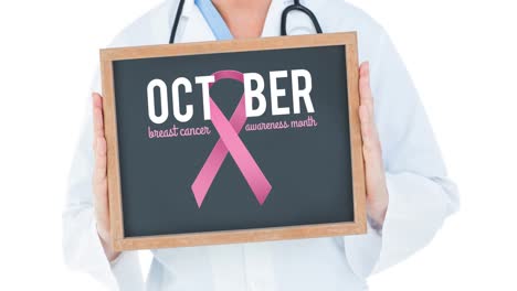 Animation-of-pink-ribbon-logo-with-breast-cancer-text-on-black-board-over-doctor