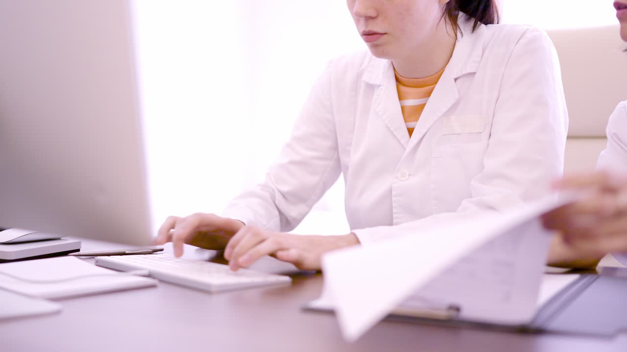 Unrecognizable healthcare worker team working in desk in a clinic
