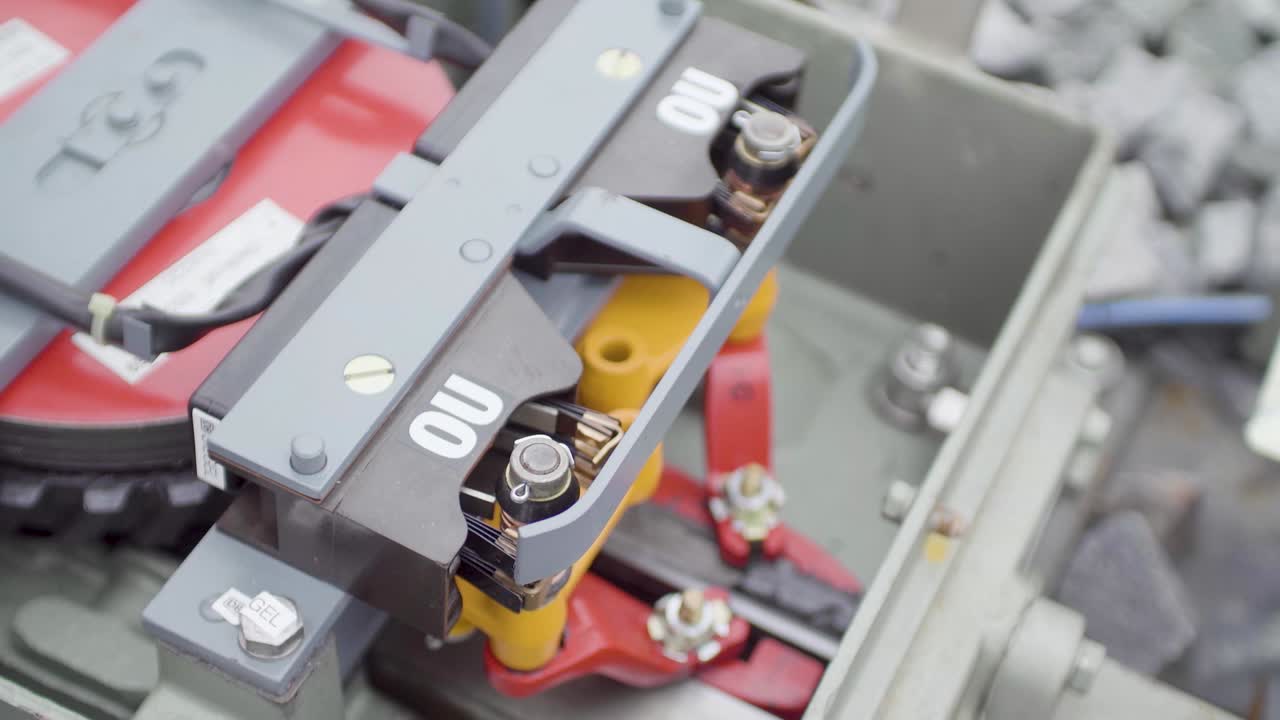Close-up of a rail clamp device on a railway, showcasing intricate mechanical details