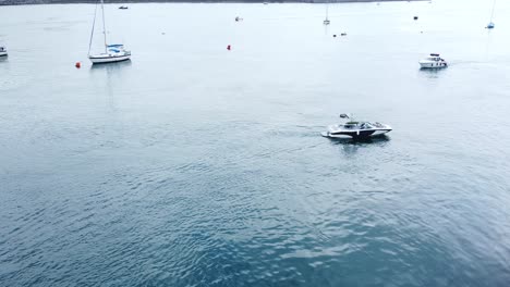 Aerial-view-overlooking-motorboats-travelling-Seaside-town-river-Conwy-harbour-marina