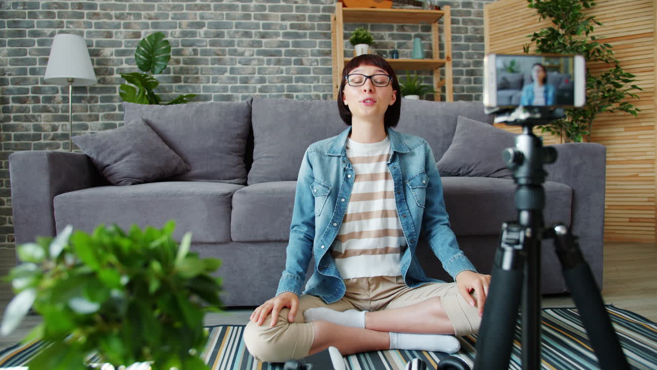 Woman vlogging in her living room