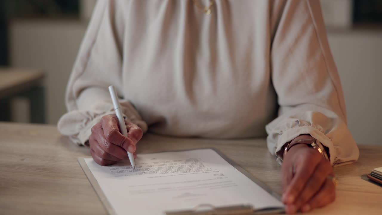 Woman Signing Document at Desk