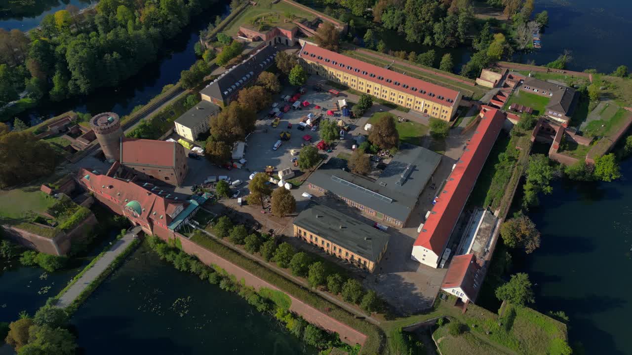 Spandau Citadel, an imposing Renaissance fortress surrounded by water, stands under a clear sky. Fabulous aerial view flight drone camera pointing down