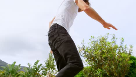 Low-angle-view-of-young-caucasian-man-practicing-skateboarding-on-ramp-in-skateboard-park-4k